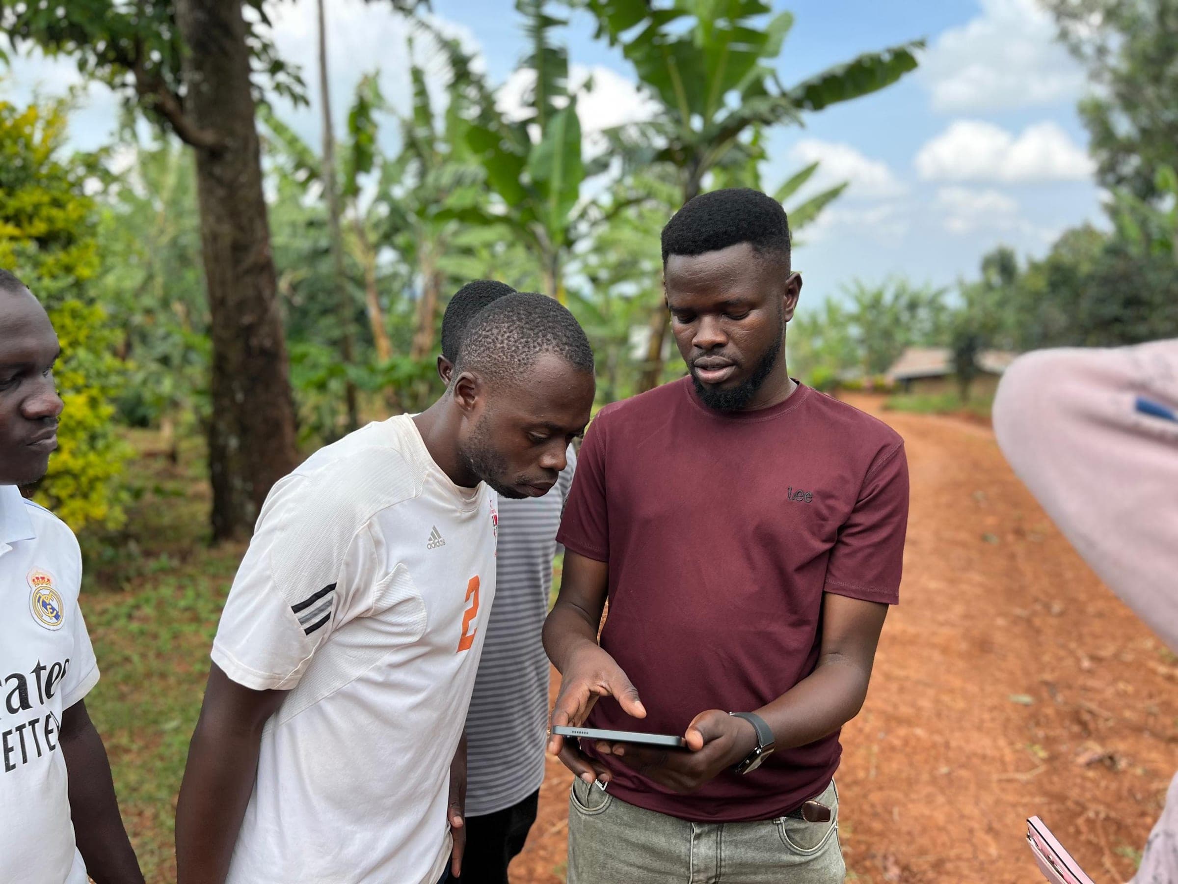 Field officers reviewing farm data on the Orijin app in the field